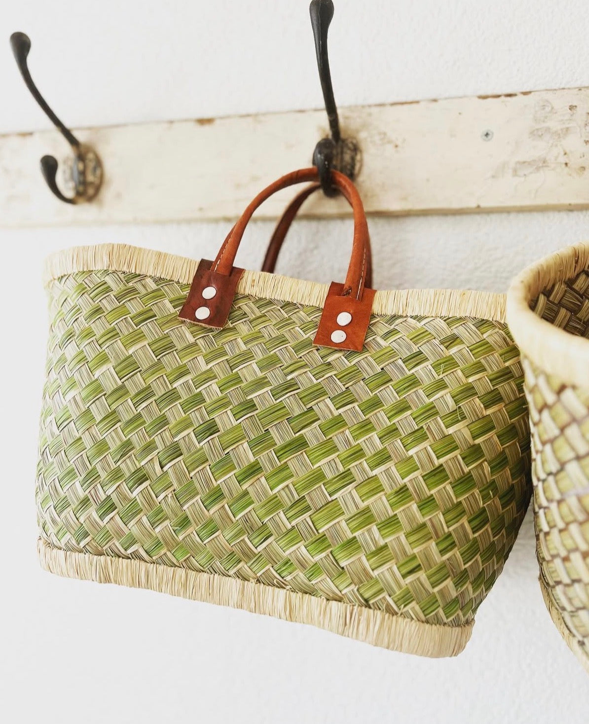 Rieten mand met leren hengsel en groene print
